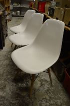 A set of six stylish moulded plastic dining chairs with beech legs.