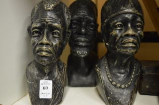 Three carved stone busts.