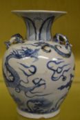 A Chinese blue and white vase decorated with a dragon.