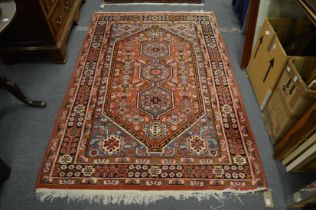 A Persian design carpet, rust ground with stylised decoration 210cm x 140cm.