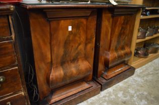 A pair of mahogany pedestal cupboards.