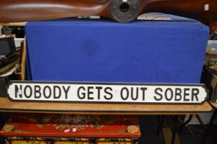 A novelty painted wood sign.