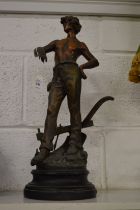 A spelter figure of a young farmer.