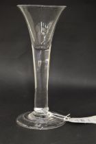 A Georgian glass with tapering bowl and tear drop in the stem.