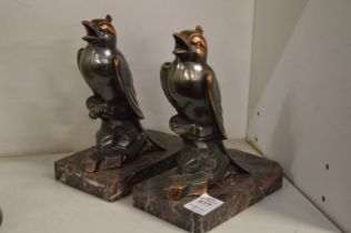 A pair of Art Deco bird bookends on marble bases.