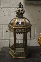 An ornate metal candle lantern.