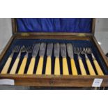 A cased set of fish knives and forks.