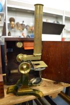 A mahogany cased brass microscope.