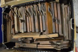 A large collection of early wood working moulding planes.