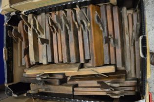A large collection of early wood working moulding planes.