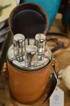 Leather cased set of three hip flasks.