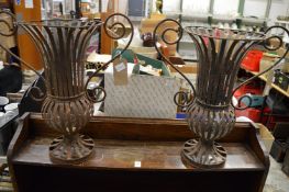 A pair of wrought iron plant holders.