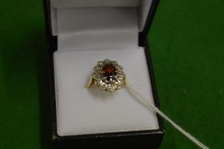 A gold diamond and garnet ring.