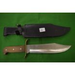 A large bowie type knife with scabbard.