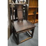 A Chinese small softwood chair with carved back panel.