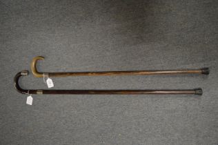 Two silver mounted walking sticks.