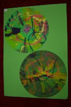 In the manner of Damien Hirst, A pair of circular spin paintings, mounted but unframed.