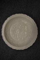 A Chinese blanc de chine circular dish with incised decoration.