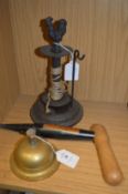 A brass table bell, a garden dibber and a garden string dispenser.