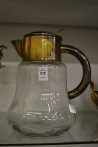 A large glass jug with plated mounts.