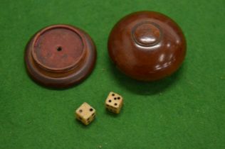 A treen box containing dice.