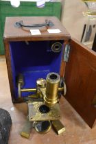 A mahogany cased brass microscope.