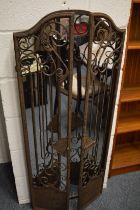 An unusual wrought iron mirror.