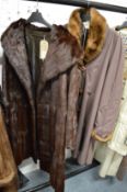 A Ladies full length mink coat and a Ladies fur trimmed coat.