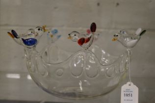 An unusual moulded glass bowl, the wavy rim decorated with colourful birds.