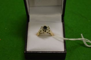 A gold diamond and sapphire ring.