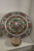 A Chinese famille rose plate together with nine similar smaller dishes.