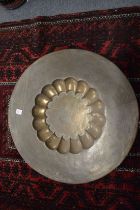 A finely engraved and chased Eastern brass circular dish.