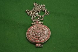 A white metal box with chain inset with pink hard stones.