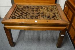 A Chinese softwood low table with lattice work top.