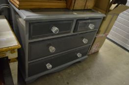 A painted chest of drawers.