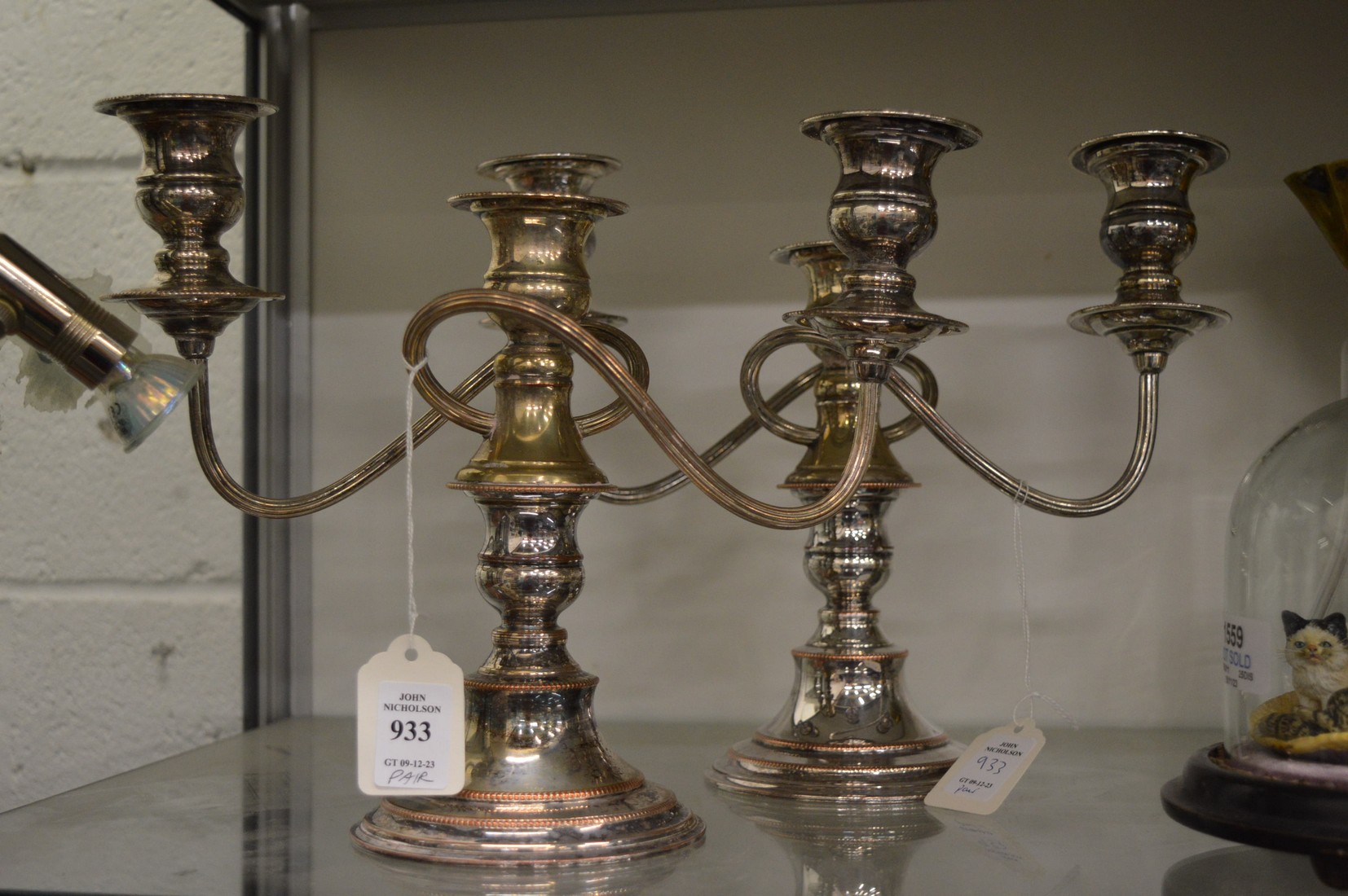 A pair of plated three light twin branch candelabra.