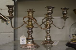 A pair of plated three light twin branch candelabra.