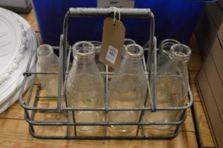 Old milk bottles and galvanized milk bottle carrier.