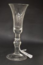 A Georgian glass with long tapering plain bowl, knop to the stem.