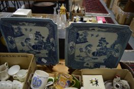 A pair of Chinese blue and white dishes on stands.