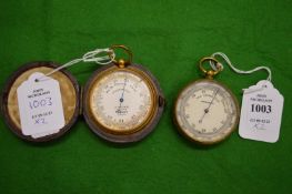 Two pocket barometers, one with original leather case.