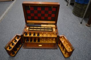 A Victorian mahogany games compendium with fitted interior.