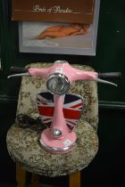 A novelty table lamp modelled as a pink Vespa scooter.