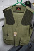 A Gentleman's green tweed shooting waistcoat with matching breeks together with a grey leather