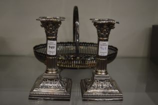 A good pair of silver corinthian column candlesticks together with a plated basket.