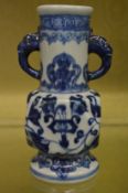 A Chinese blue and white vase with elephant handles.