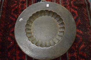 An Eastern finely engraved and enamel circular brass tray.