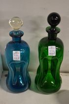 Two coloured glass hour glass decanters.