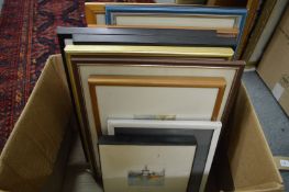 A box of assorted paintings and prints.