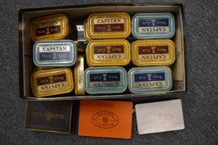 A large quantity of coins of the world contained in old Capstan and cigarette tins.